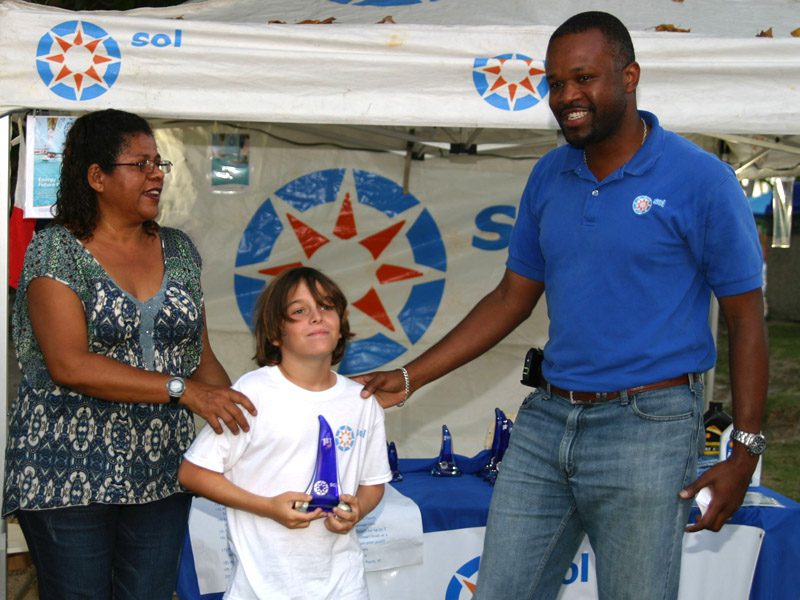 Rayne Duff receives his first place prize from Sol BVI's Chief Operations Manager, Konris Maynard